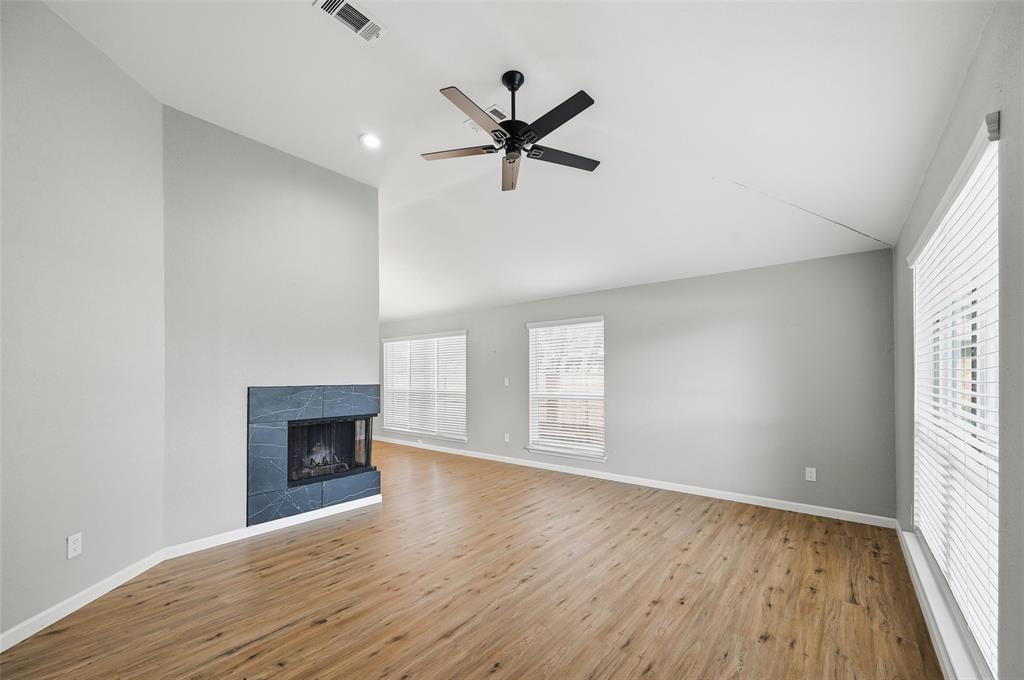 210 South Malone Road Allen, TX 75002 - Photo 5 of 36 an empty room with windows a fireplace