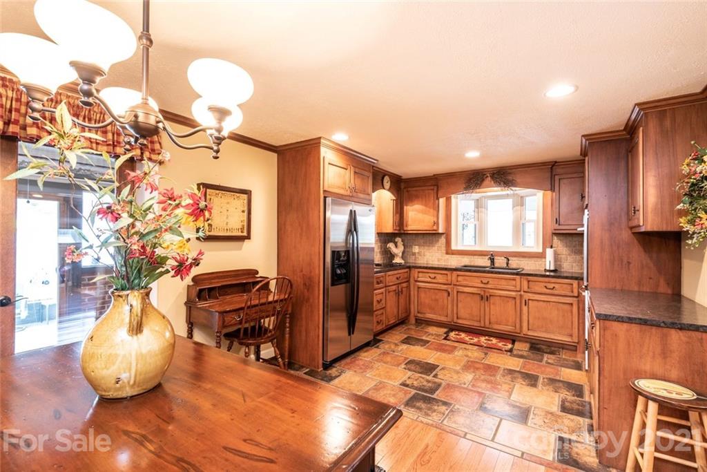 3040 Deal Mill Road Hudson, NC 28638 - Photo 14 of 48 a large kitchen with a table and chairs