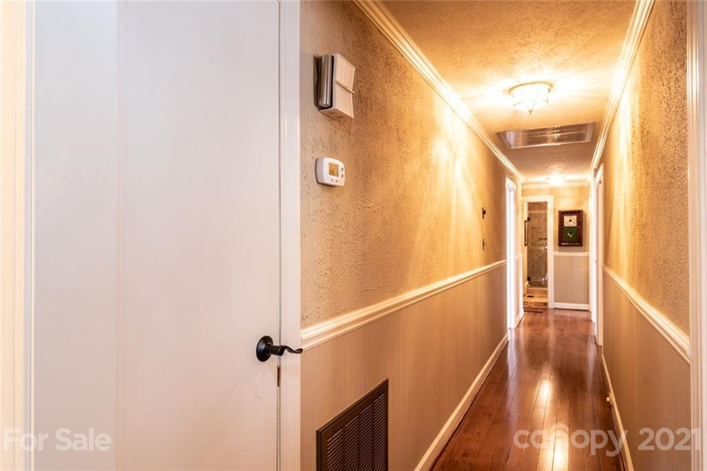 3040 Deal Mill Road Hudson, NC 28638 - Photo 22 of 48 a view of a hallway with wooden floor and staircase