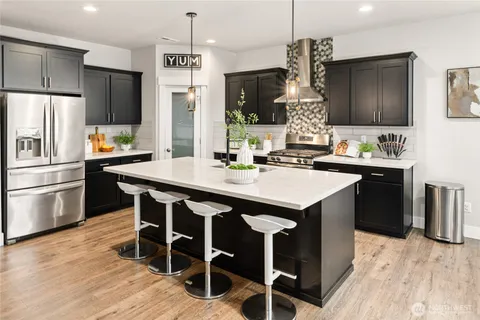 a kitchen with granite countertop a sink appliances cabinets and counter space