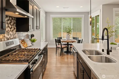 a kitchen with stove and a sink