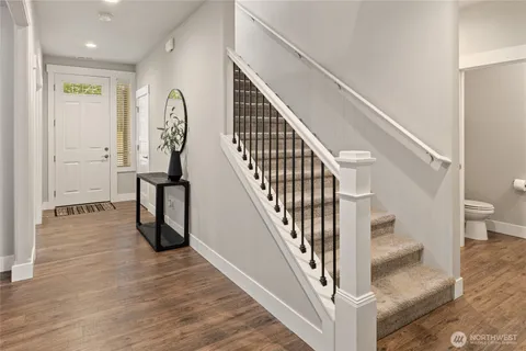 a view of entryway and hall with wooden floor