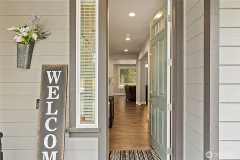 a view of hallway with livingroom and chandelier