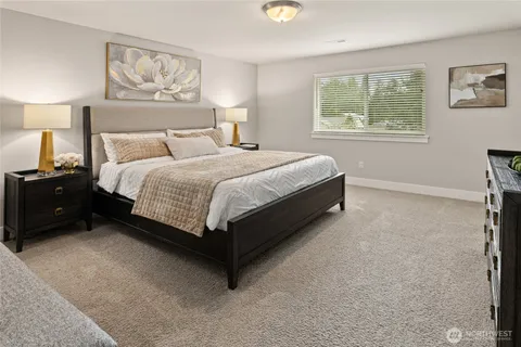 a bed sitting in a bedroom next to a window