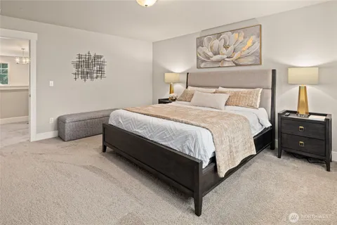 a spacious bedroom with a bed and wall painting