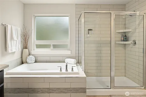 a bathroom with a bathtub and a shower