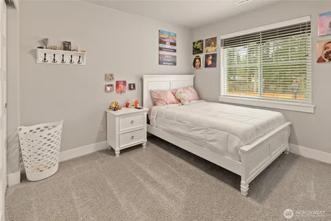 a bedroom with a bed and a large window