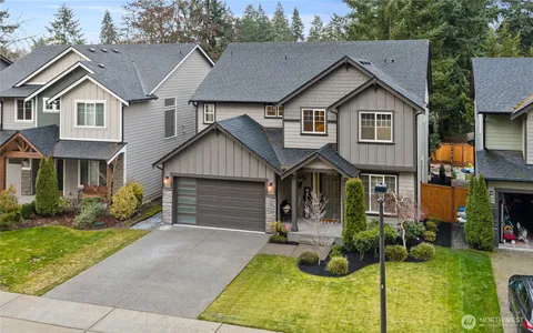 a view of small house with garage