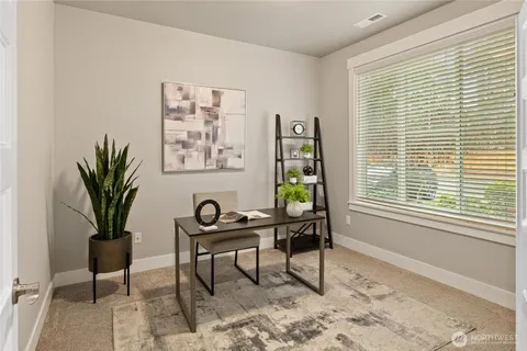 a workspace with furniture and a window