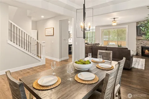 a dining room with furniture a window and wooden floor