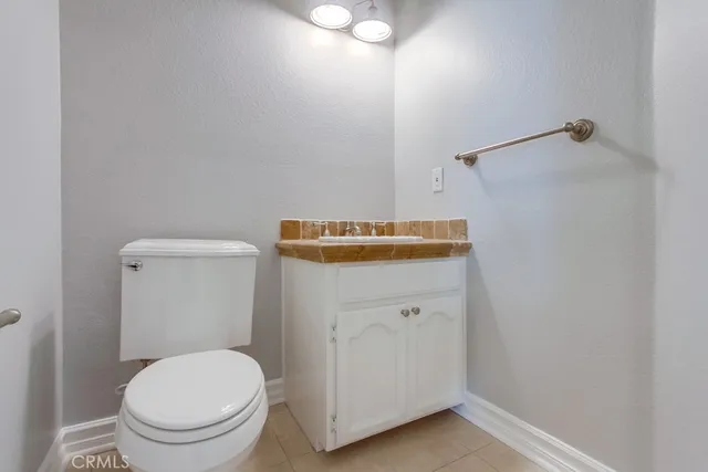 a white toilet sitting next to a bathroom sink
