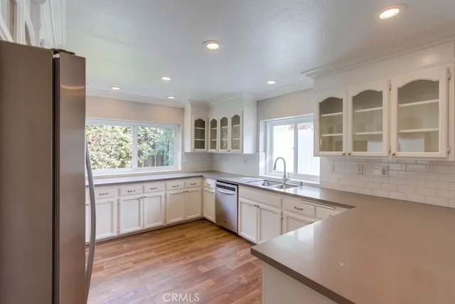 a large kitchen with granite countertop lots of counter space and windows