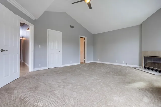 a view of an empty room with a fireplace