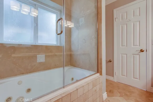 a bathroom with a tub and shower