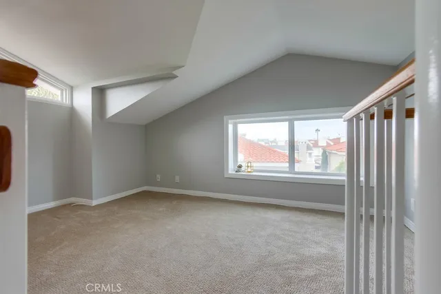 a view of a hallway with windows and stairs
