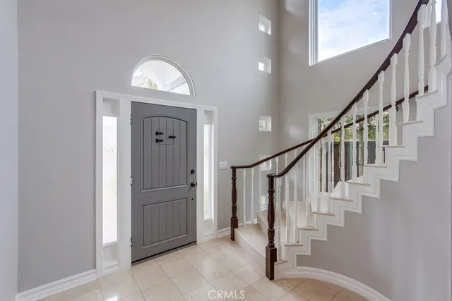 a view of entryway with wooden floor and stairs