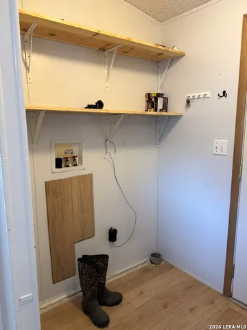 a view of a kitchen with kitchen island a sink a stove and a refrigerator