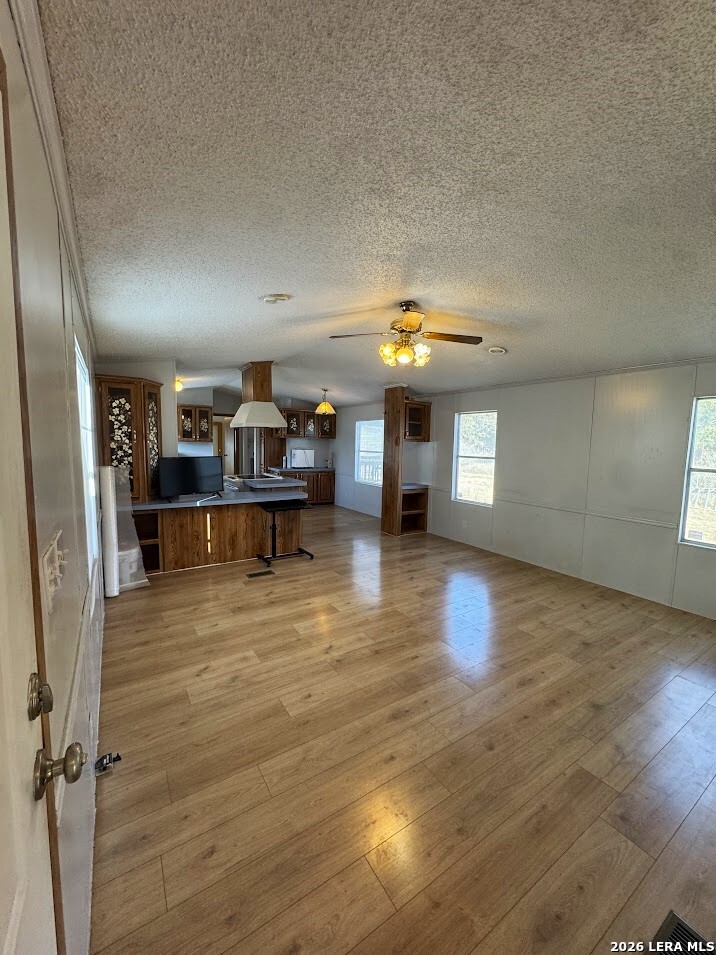 2057 Indian Hills Drive Spring Branch, TX 78070 - Photo 10 of 15 a view of a living room and kitchen with furniture and wooden floor