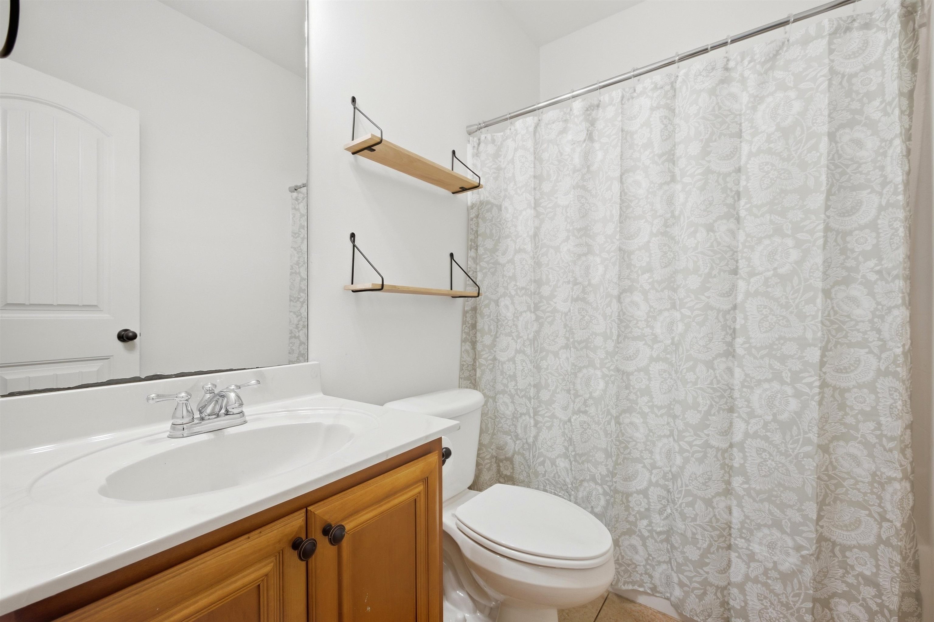7920 Pips Ridge Lane Bartlett, TN 38133 - Photo 25 of 40 Wood-finish vanity with a white countertop and oval sink