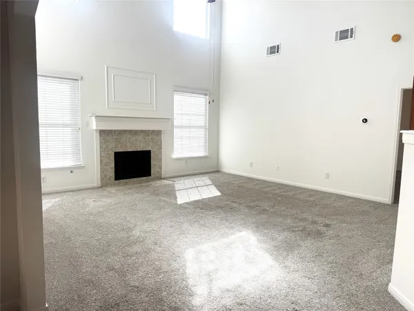 a view of an empty room with a fireplace