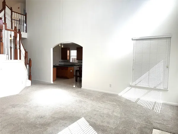 a view of a livingroom with furniture and staircase