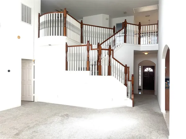 a view of staircase with white walls and a window