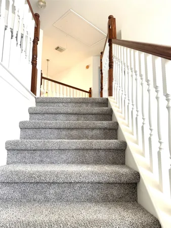 a view of staircase with white walls