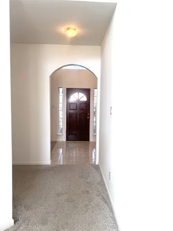 a view of a hallway with an entryway