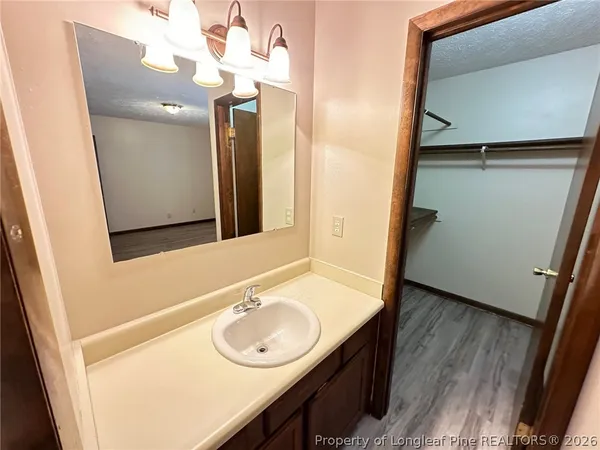 a white toilet sitting next to a bath tub