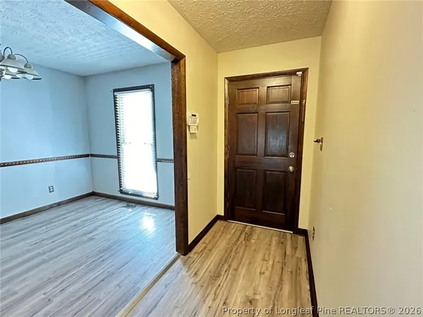 an empty room with wooden floor and closet