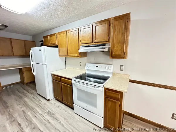 a kitchen with a stove a sink and a refrigerator