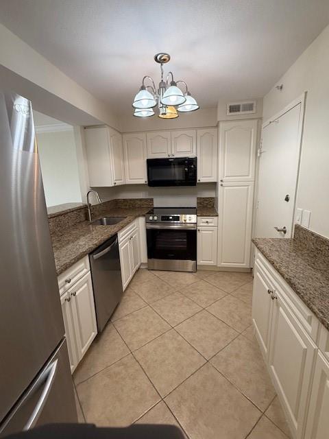 1900 South Ocean Boulevard, Unit 7J Lauderdale-by-the-Sea, FL 33062 - Photo 5 of 30 a kitchen with stainless steel appliances granite countertop a stove a sink and a refrigerator