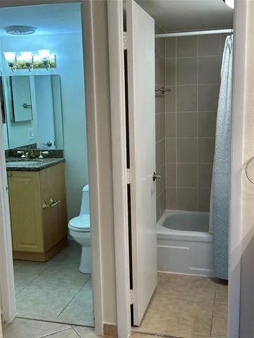a bathroom with a shower and a toilet