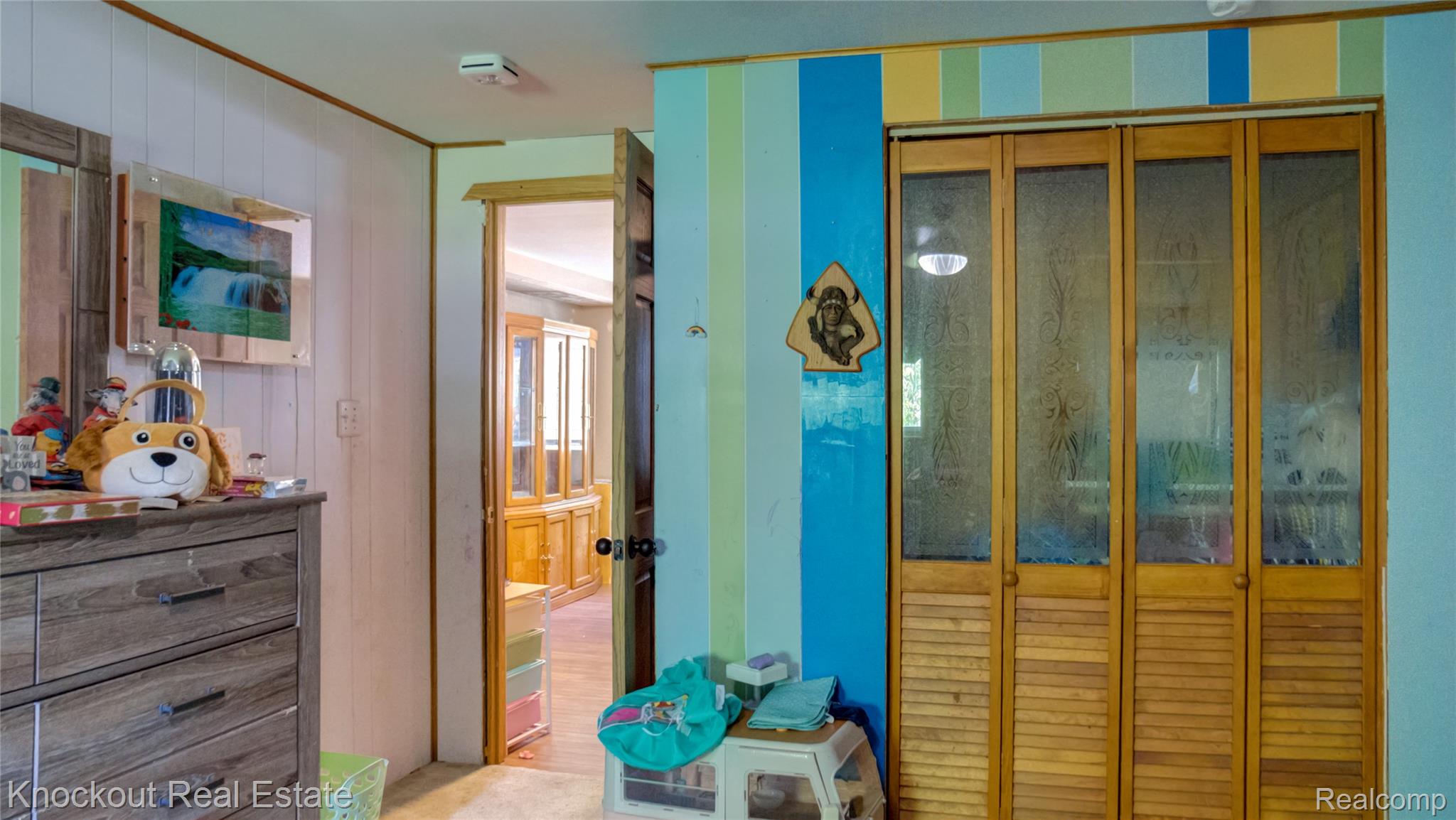 4195 Williamson Road Saginaw, MI 48601 - Photo 26 of 50 Bi-fold closet doors featuring louvered wood panels and glass inserts