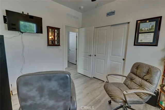 a living room with furniture and a book shelf