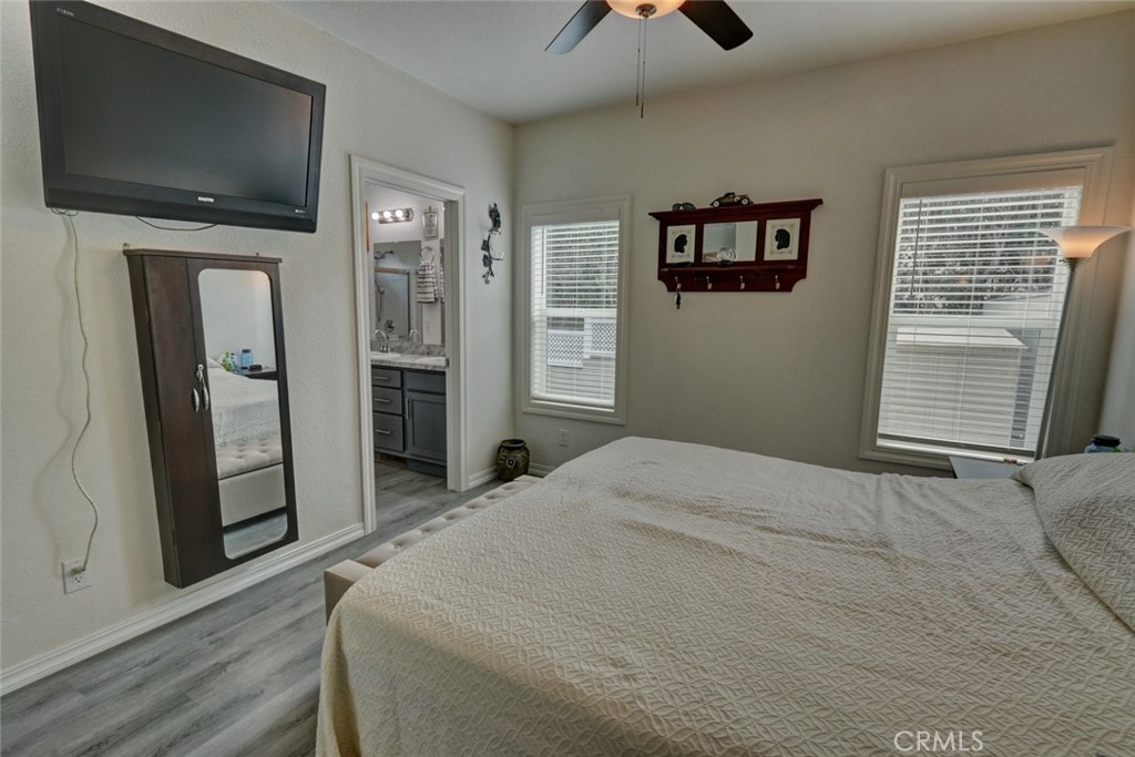 22221 Bloomfield Street, Unit 47 Cypress, CA 90630 - Photo 14 of 30 a bedroom with a bed and a flat screen tv