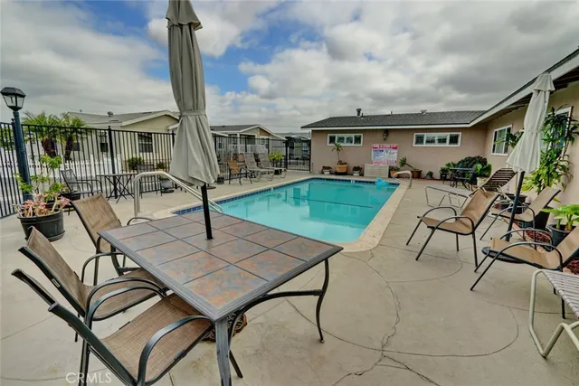 a view of a house with swimming pool and sitting area