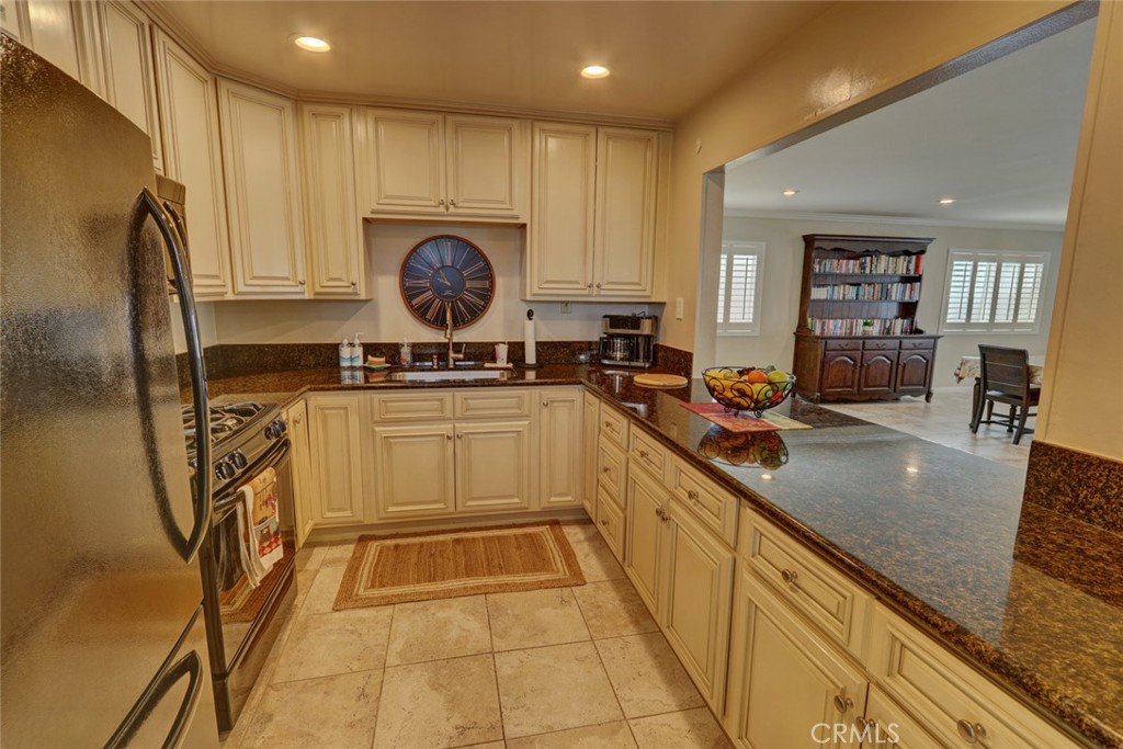 22221 Bloomfield Street, Unit 47 Cypress, CA 90630 - Photo 28 of 30 a kitchen with sink cabinets and stainless steel appliances