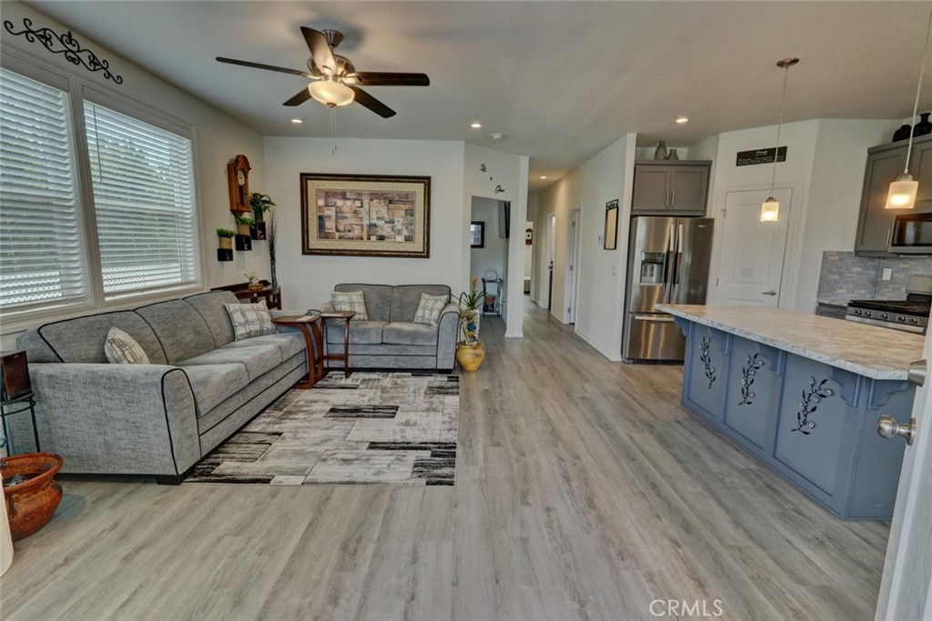 22221 Bloomfield Street, Unit 47 Cypress, CA 90630 - Photo 30 of 30 a living room with furniture and a wooden floor