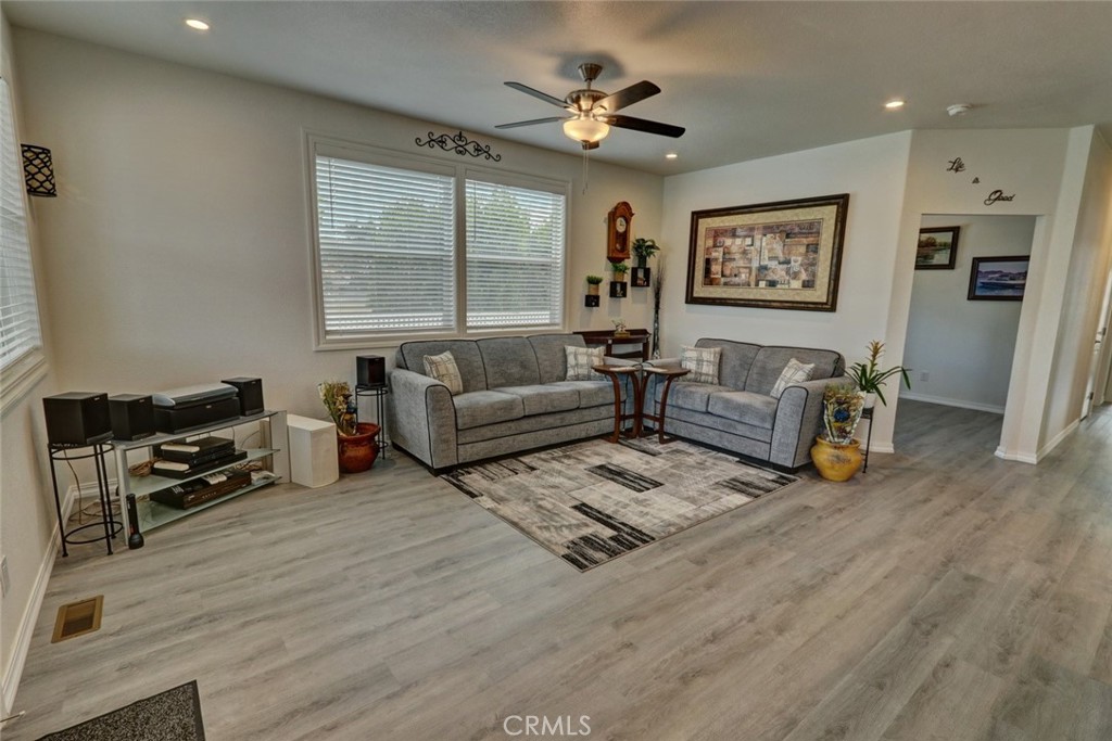 22221 Bloomfield Street, Unit 47 Cypress, CA 90630 - Photo 3 of 30 a living room with furniture and a wooden floor