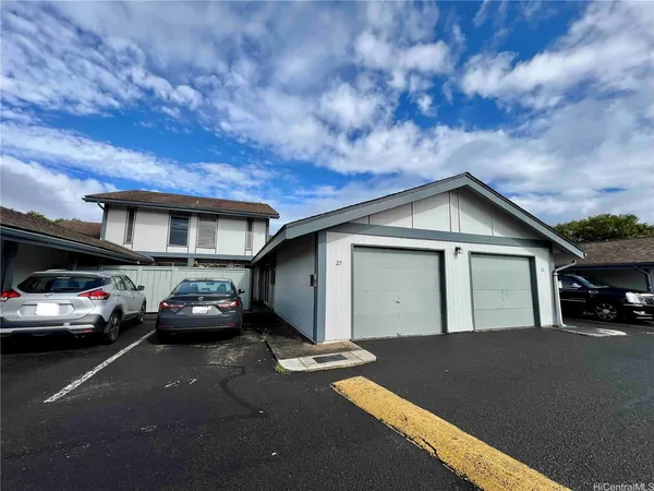 a view of a car park in front of house