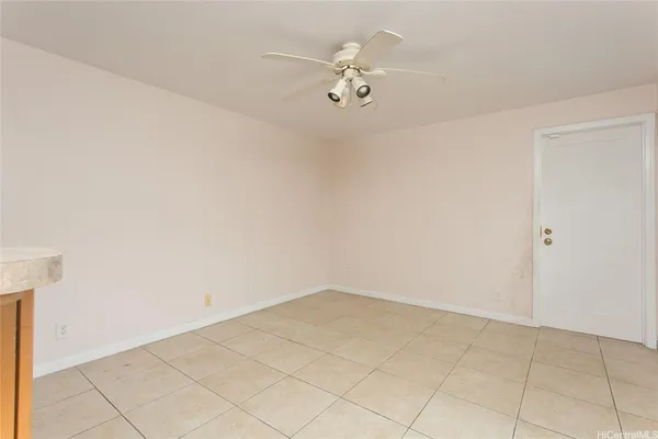 an empty room with a ceiling fan