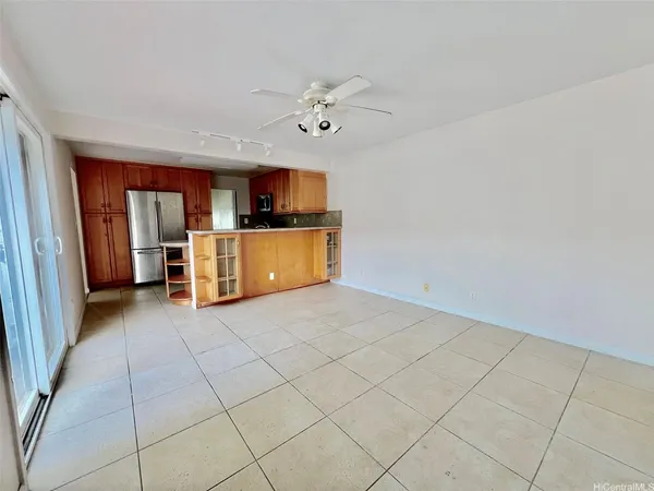 a view of a kitchen with a sink cabinet a microwave and a refrigerator
