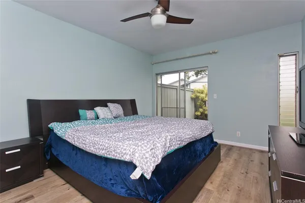 a bed sitting in a bedroom next to a window