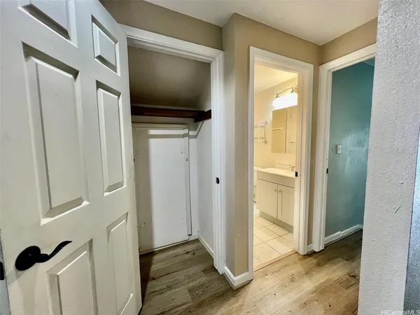 a view of a livingroom with wooden floor and a flat screen tv