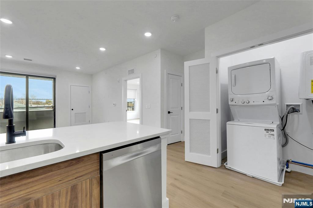 255 Ridge Road, Unit 201 Lyndhurst, NJ 07071 - Photo 21 of 24 a kitchen with a sink appliances and cabinets