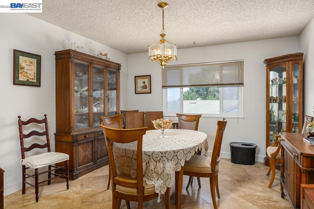4591 Edwards Lane Castro Valley, CA 94546 - Photo 9 of 44 a dining room with furniture a chandelier and window