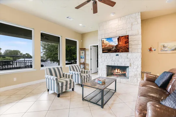 a kitchen with stainless steel appliances granite countertop a stove top oven a sink dishwasher a dining table and chairs with wooden floor