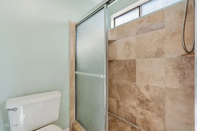 a bathroom with a sink vanity mirror and toilet
