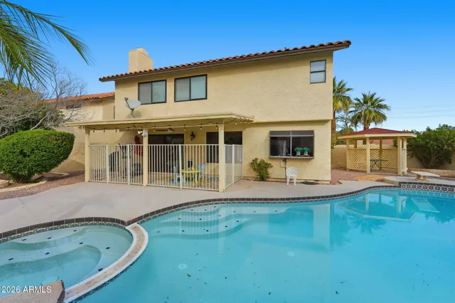an aerial view of a house with garden space and ocean view